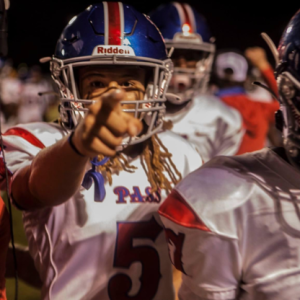 pass christian football player in uniform points at camera