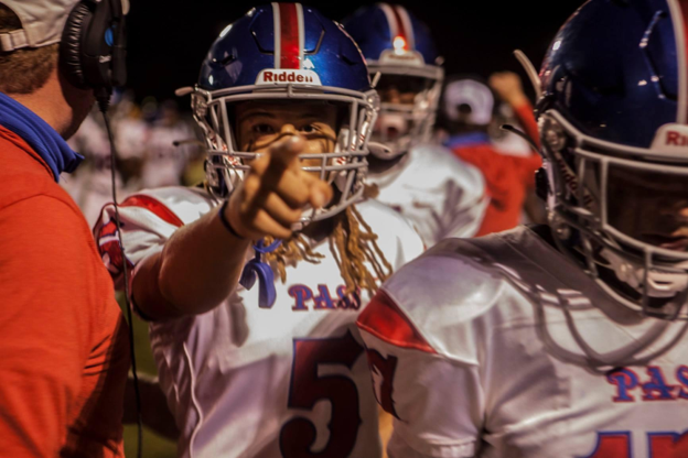 pass christian football player in uniform points at camera