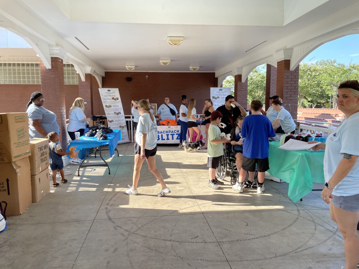 Local students lined up to get their free backpacks filled with school supplies at the Backpack Blitz held in downtown Long Beach. (Photo credit: Melanie Buford)