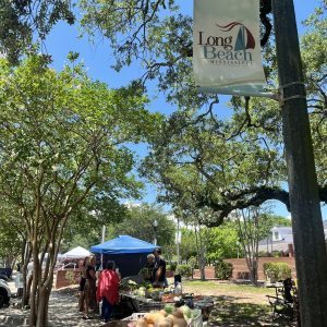 People lined up at DJ's Produce, a staple at the Long Beach Art and Artisans Market, where farm-to-table, fresh produce and other goods, including homemade jams by Southern Grace Farms, are available for purchase. ( Photo: Toni Miles)